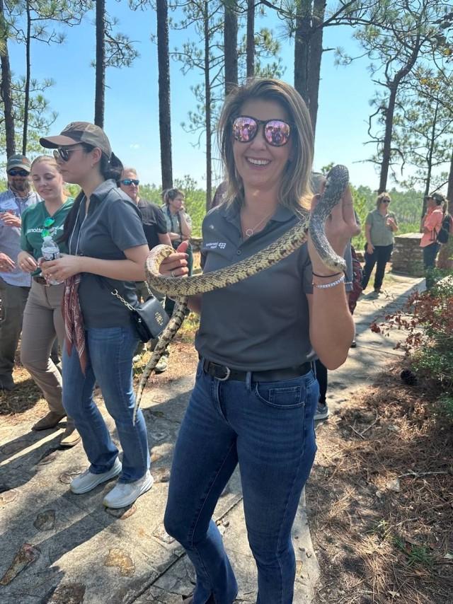 An IP employee holds a Louisiana pine snake
